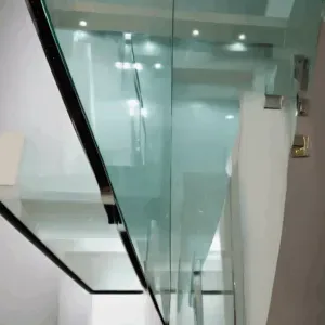 Close-up of edge grinding and polishing process on a 3mm toughened glass sheet in Bangalore, showcasing precision work.