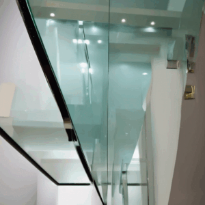 Close-up of edge grinding and polishing process on a 3mm toughened glass sheet in Bangalore, showcasing precision work.